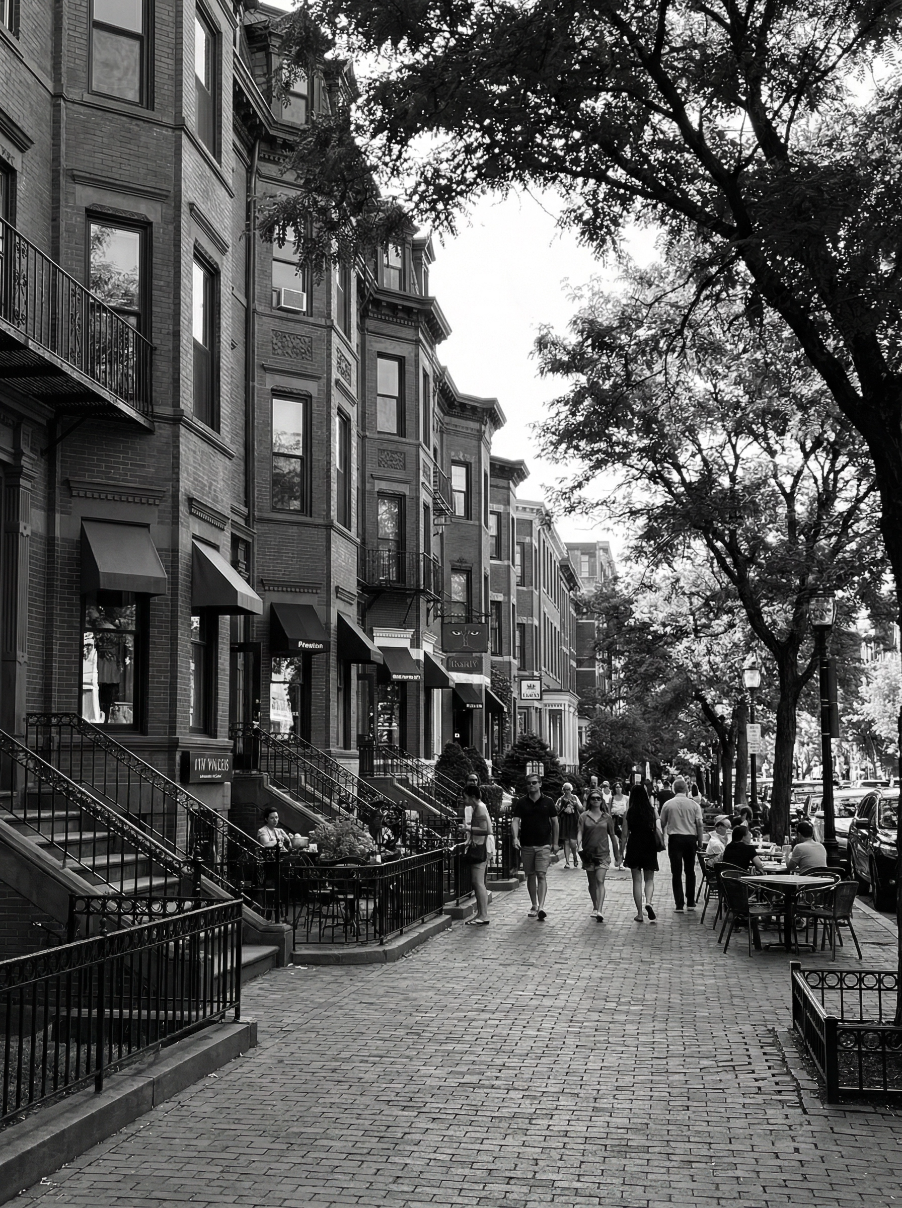 Historic brownstones and sidewalk cafes along Newbury Street in Back Bay Boston