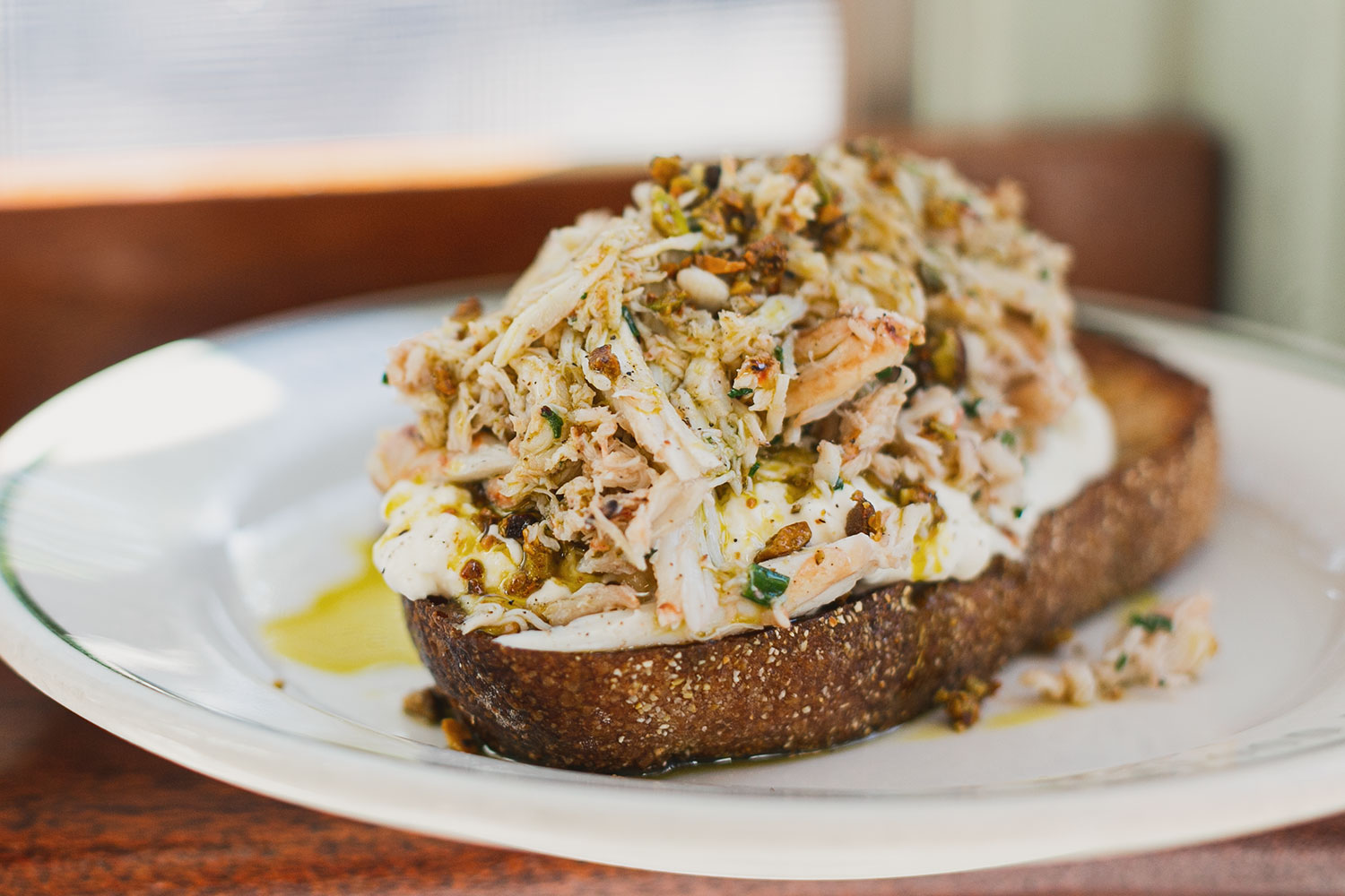 Crab toast with shredded crab meat on grilled bread at Saltie Girl Back Bay Boston